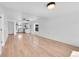 Spacious living room featuring light wood floors, white walls, and a ceiling fan at 3064 S Galapago St, Englewood, CO 80110