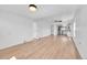Bright living room featuring light wood floors, white walls, and access to the kitchen at 3064 S Galapago St, Englewood, CO 80110