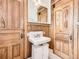 Bathroom features vintage sink, wood paneling and trim with a tiled floor at 1453 Vine St, Denver, CO 80206