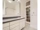 Bright bathroom with a large mirror, classic vanity, and a glass-paneled door at 1453 Vine St, Denver, CO 80206