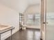 Bright bathroom with large window, neutral tile, and standalone sink at 1453 Vine St, Denver, CO 80206