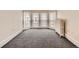 Bedroom featuring gray carpet, bay windows with radiator, and neutral paint at 1453 Vine St, Denver, CO 80206