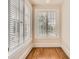 Bedroom with hardwood flooring, white trim, and windows with window coverings at 1453 Vine St, Denver, CO 80206