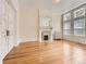 Bedroom featuring hardwood floors, decorative molding, and a fireplace with carved mantle at 1453 Vine St, Denver, CO 80206