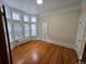 Bright bedroom with hardwood floors, large windows, and traditional radiator at 1453 Vine St, Denver, CO 80206