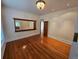 Cozy bedroom featuring hardwood floors, neutral paint, large mirror, and doorway to additional spaces at 1453 Vine St, Denver, CO 80206