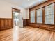 Bedroom showcasing original wood detailing, hardwood floors, and a view into the kitchen at 1453 Vine St, Denver, CO 80206