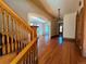 Classic foyer showcasing hardwood floors, staircase with wooden banister, and arched doorways into adjoining rooms at 1453 Vine St, Denver, CO 80206