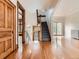 Foyer view with hardwood floors, stairs, and natural wood trim throughout at 1453 Vine St, Denver, CO 80206