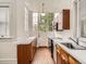 Kitchen features wood cabinets, stainless steel appliances, white countertops, large windows and a door to the outside at 1453 Vine St, Denver, CO 80206