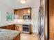 Charming kitchen featuring stainless steel appliances, granite countertops, and wooden cabinets at 1453 Vine St, Denver, CO 80206