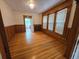 Cozy living room with hardwood floors, wood trim, and a bright window view at 1453 Vine St, Denver, CO 80206