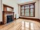 Living room with fireplace, hardwood floors, large bay window and wood trim at 1453 Vine St, Denver, CO 80206