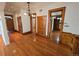 Spacious living room with hardwood floors, chandelier lighting, and an open doorway into other rooms at 1453 Vine St, Denver, CO 80206