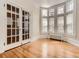 Bright room featuring hardwood floors, tall windows, and decorative glass paneled doors at 1453 Vine St, Denver, CO 80206