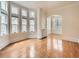 Inviting living room with hardwood floors, large windows, and archway to dining area at 1453 Vine St, Denver, CO 80206