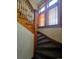 Carpeted staircase featuring detailed wood banister and trim lit by natural light from nearby windows at 1453 Vine St, Denver, CO 80206