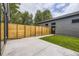 Modern backyard features concrete patio and grass area, fully fenced with privacy at 2378 S Bannock St, Denver, CO 80223
