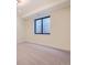 Large basement with a bright window and carpeted floor perfect for a media room or play area at 2378 S Bannock St, Denver, CO 80223
