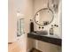 Modern half bath features a vessel sink with stylish fixtures and a decorative mirror at 2378 S Bannock St, Denver, CO 80223