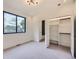 Well-lit bedroom with carpet, large windows, closet and neutral paint colors at 2378 S Bannock St, Denver, CO 80223