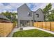 Modern gray home with a fenced yard and green grass area, offering an inviting outdoor space at 2378 S Bannock St, Denver, CO 80223