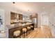 Beautiful kitchen features a large island, wood cabinets, stainless appliances, hardwood floors, and modern lighting at 2378 S Bannock St, Denver, CO 80223