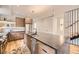 Modern kitchen features a large center island with stone countertop, stainless steel appliances, and custom wood cabinetry at 2378 S Bannock St, Denver, CO 80223