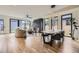 Open concept featuring a modern dining room and living room with stylish fireplace, hardwood floors, and large windows at 2378 S Bannock St, Denver, CO 80223