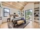 Cozy bedroom features a wood ceiling, large windows, hardwood floors, and a comfortable bed at 2378 S Bannock St, Denver, CO 80223