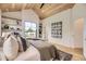 Bright main bedroom with wood ceiling, hardwood floors, built-in shelves, and a large window overlooking the neighborhood at 2378 S Bannock St, Denver, CO 80223