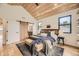Comfortable main bedroom with hardwood floors, a decorative wood sliding door, and stylish furnishings at 2378 S Bannock St, Denver, CO 80223