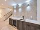 Finished basement wet bar featuring stylish tile backsplash, stone countertop, and beverage refrigerator at 2378 S Bannock St, Denver, CO 80223