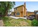 Backyard view showcasing a spacious lawn, patio, and wood pile at 20651 E 42Nd Ave, Denver, CO 80249
