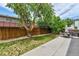 Backyard featuring a grassy yard, wooden fence, and concrete patio at 20651 E 42Nd Ave, Denver, CO 80249