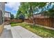 Backyard featuring a grassy yard, wooden fence, and concrete patio at 20651 E 42Nd Ave, Denver, CO 80249
