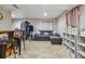 Basement including a bar, sofa, shelving and tiled floors at 20651 E 42Nd Ave, Denver, CO 80249