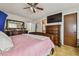 Spacious primary bedroom features a dresser, TV, and closet, providing ample space for relaxation and storage at 20651 E 42Nd Ave, Denver, CO 80249