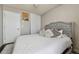Bedroom with tiled flooring, bed with pillows, headboard, closet and white door at 20651 E 42Nd Ave, Denver, CO 80249