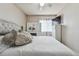 Bedroom featuring a bed, tiled floor, headboard, TV, and vanity area with great lighting at 20651 E 42Nd Ave, Denver, CO 80249