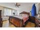 Comfortable bedroom includes ample space, a ceiling fan, and natural light from the window at 20651 E 42Nd Ave, Denver, CO 80249