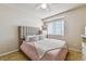 Cozy bedroom featuring a bed, headboard, tiled floors and large window at 20651 E 42Nd Ave, Denver, CO 80249