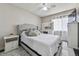 Bedroom with large bed, nightstand, tiled floor, vanity area and natural light from a window at 20651 E 42Nd Ave, Denver, CO 80249