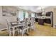 Bright dining area features elegant furniture, large window, and modern fixtures near a stylish, updated kitchen at 20651 E 42Nd Ave, Denver, CO 80249