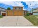 A two-story home with a three-car garage, stone accents and manicured lawn on a sunny day at 20651 E 42Nd Ave, Denver, CO 80249
