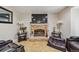 Close-up of fireplace with mantel, decorative accessories, and comfortable seating, creating a cozy and inviting atmosphere at 20651 E 42Nd Ave, Denver, CO 80249