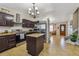 Modern kitchen featuring dark wood cabinets, stainless steel appliances, and a granite island at 20651 E 42Nd Ave, Denver, CO 80249