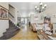 Spacious living room with tile floors, a staircase, and view of the dining area at 20651 E 42Nd Ave, Denver, CO 80249