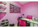 A nail salon room with pink walls and a nail station with two pink chairs at 20651 E 42Nd Ave, Denver, CO 80249