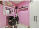 Salon room featuring pink walls, shelving, and a styling chair at 20651 E 42Nd Ave, Denver, CO 80249